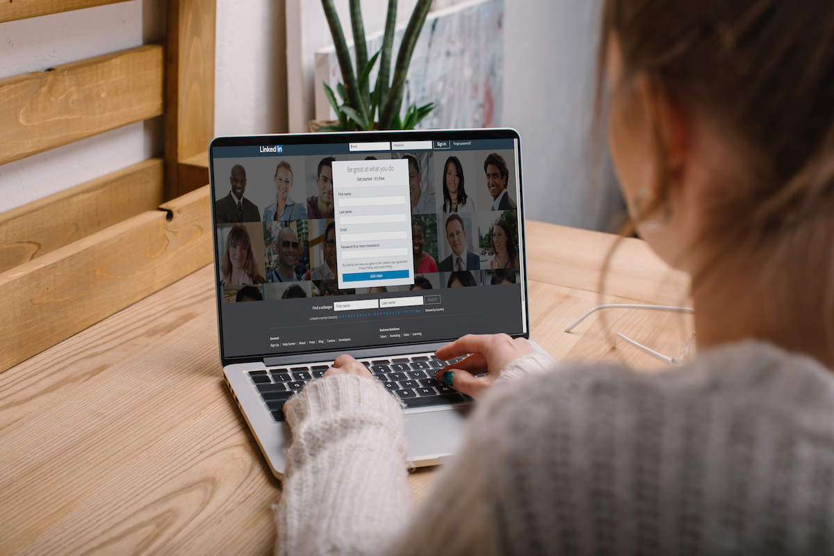 Girl watching engaging LinkedIn video on laptop